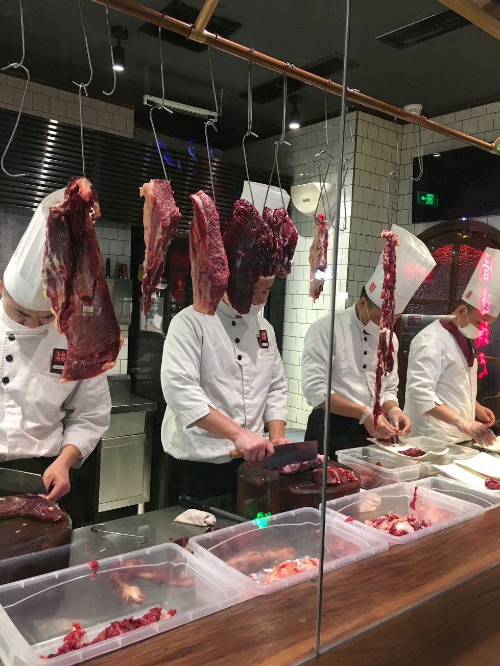 Variety of meat being cut by chefs